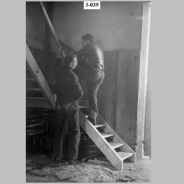 Two men working on a staircase.jpg